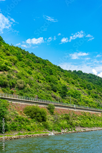 Germany  Rhine Romantic Cruise  a bridge over a body of water with a mountain in the background