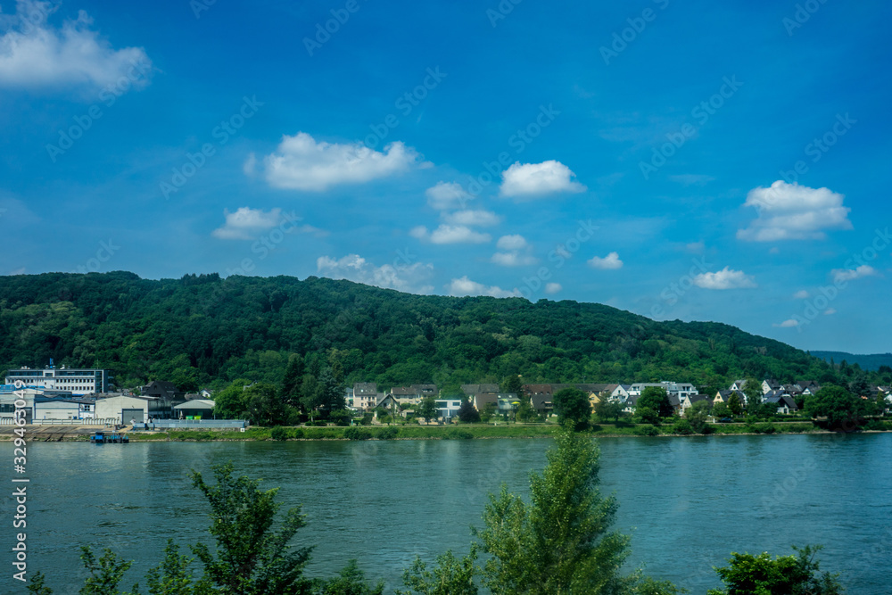 Germany, Hiking Frankfurt Outskirts, a small boat in a body of water with a mountain in the background