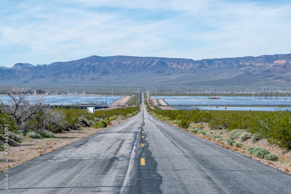 Road to the Future of Renewable Energy Development between fields of solar power plants in Eldorado Valley, Nevada, USA