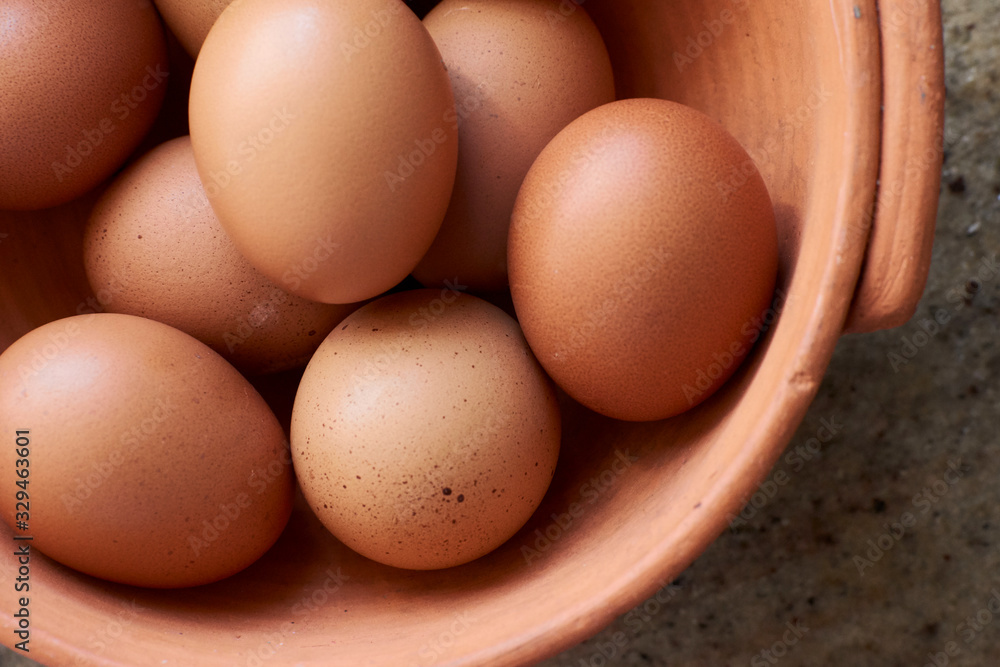 Close up of eggs in a pottery basket Close up of eggs in a pottery basket