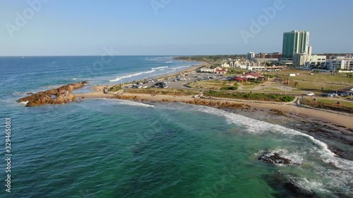 beautiful beachfront and rocks at Pollock Beach revealed in aerial slider movement photo