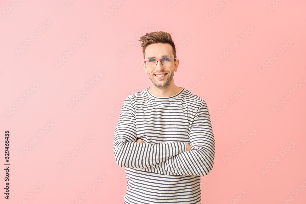 Young man with stylish eyeglasses on color background Young man with stylish eyeglasses on color background