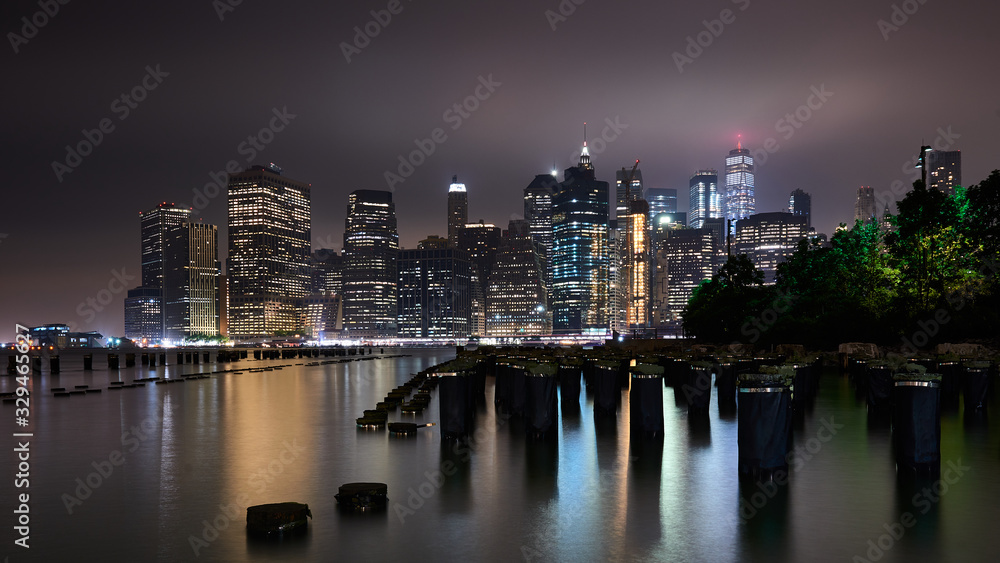 Lower Manhattan skyline, New York skyline at night by the dock Lower Manhattan skyline, New York skyline at night by the dock