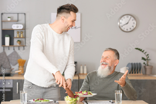Senior man and his adult so...