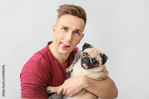 Handsome man with cute pug ...