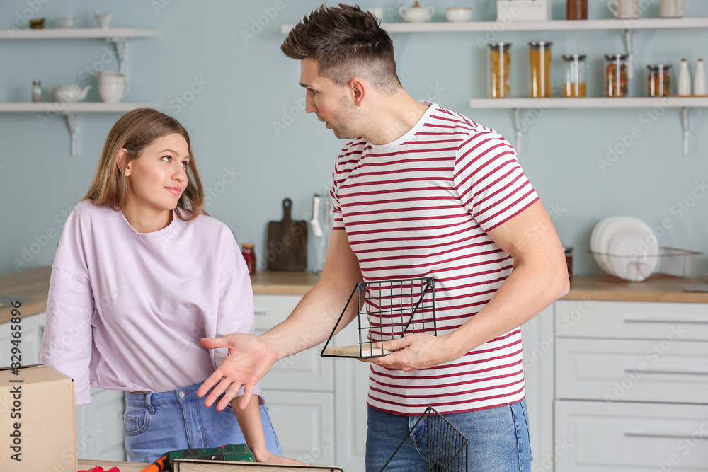 Emotional couple assembling furniture at home Emotional couple assembling furniture at home