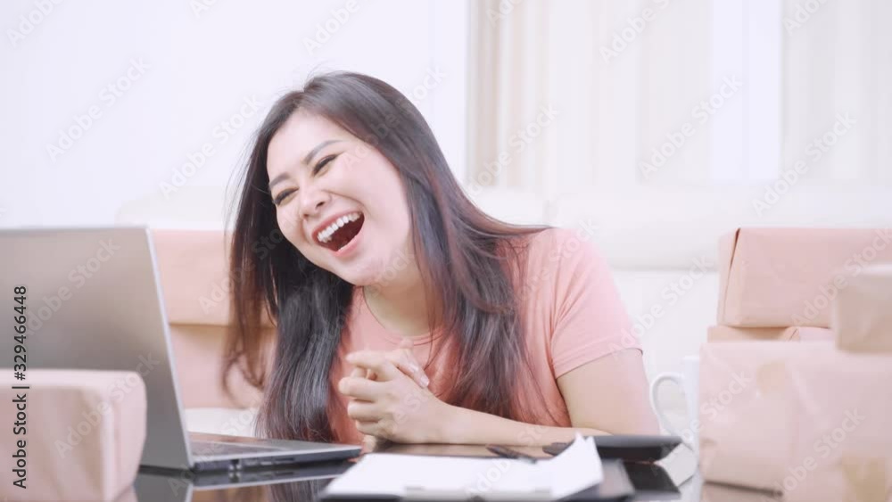 Happy female online seller expressing her success Happy female online seller expressing her success