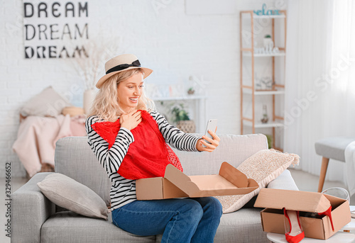 Happy young woman unpacking...