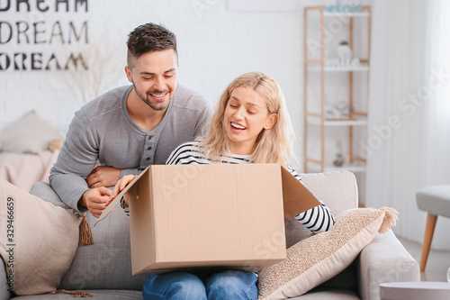 Happy young couple unpackin...