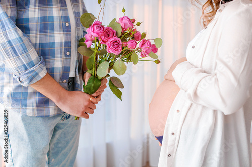 Husband giving bouquet of f...