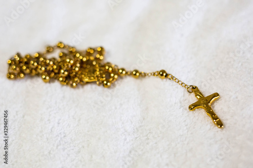 Obraz na plátně Isolated golden holy cross on chain christian symbol