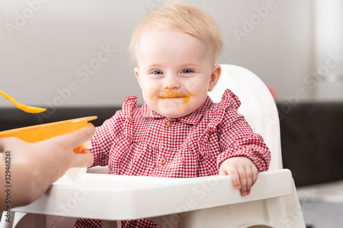 Mother Feeding Baby With Spoon