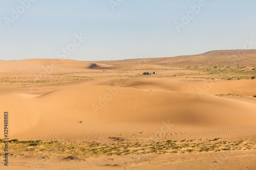 Mongolia Gobi desert, minibus and tourist tent in Khongor sand dunes