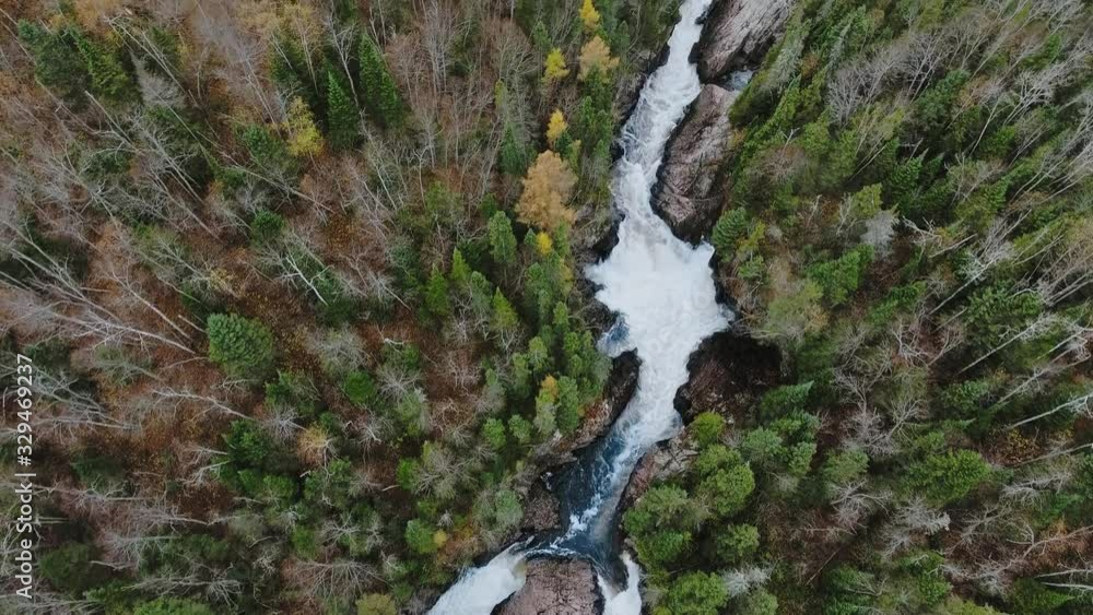 Aerial shot of beautiful autumn forest and running water between the shores (Aguasabon Falls, Ontario, Canada) Aerial shot of beautiful autumn forest and running water between the shores (Aguasabon Falls, Ontario, Canada)