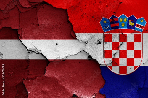 flags of Latvia and Croatia painted on cracked wall