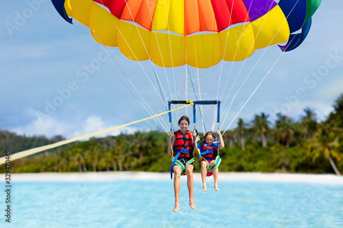 Kids parasailing. Water sport on summer vacation.