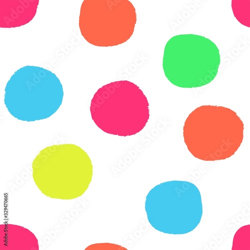 Vector seamless repeat pattern with big bold kids birthday party multi bright colorful colourful hot neon irregular hand-drawn polka dots with rough grunge edges on a white background