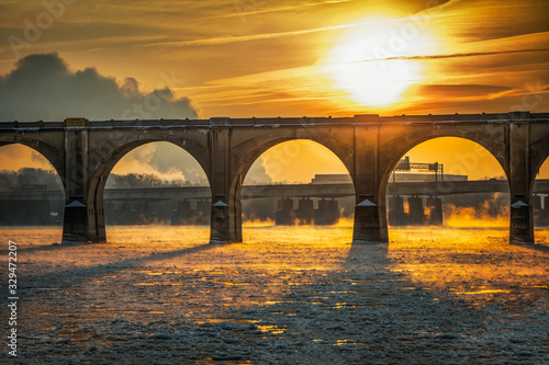 A blazing sunrise over a railroad bridge in Harrisburg, Pennsylvania photo
