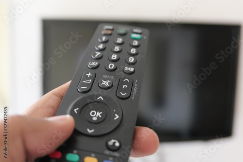 Close up of man hand use Tv remote 