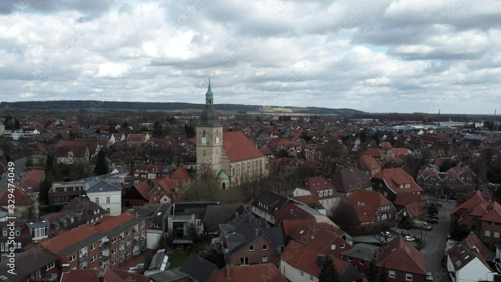 Dolly aerial drone view of ancient church in middle of buildings with red rooftops Dolly aerial drone view of ancient church in middle of buildings with red rooftops