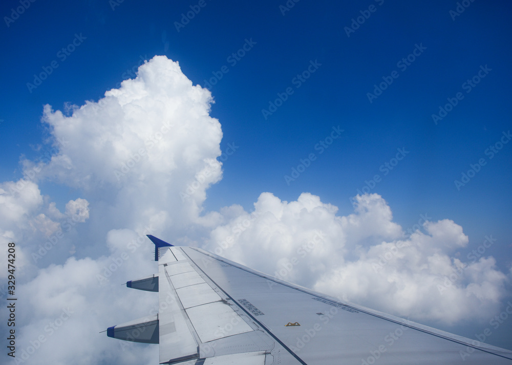 Airplane wing on the sky looking through the airplane window. Airplane wing on the sky looking through the airplane window.