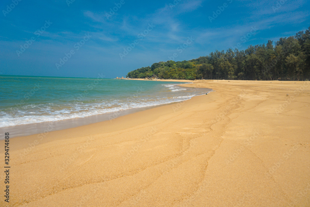 Golden sand beach has sand, sea water, sand, the sea water on the sand.