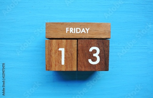 Friday 13th on wooden calendar. bad luck, Misfortune Day, Halloween Concept.