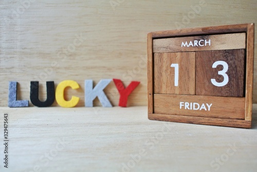 Friday 13th on wooden calendar. bad luck, Misfortune Day, Halloween Concept.