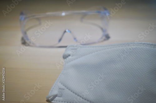 Virus protection equipment sensitizer sprayer respiratory mask and glasses on the table