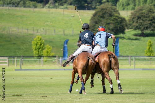 Polo scrum between two players on the field