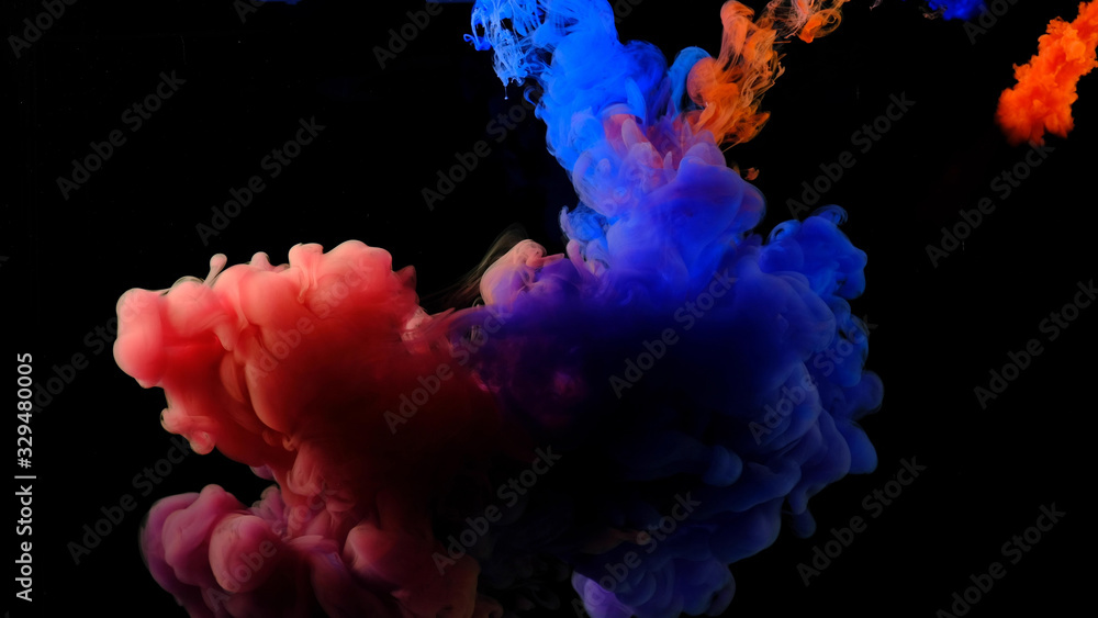 Obraz premium Color drops in water , abstract color mix , drop of Ink color mix paint falling on water Colorful ink in water, 