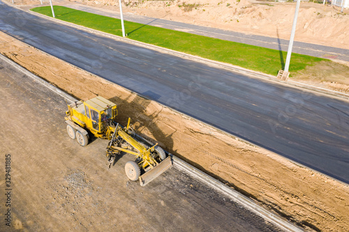 road grader on road construction site. machines work on the construction of new road. aerial view photo