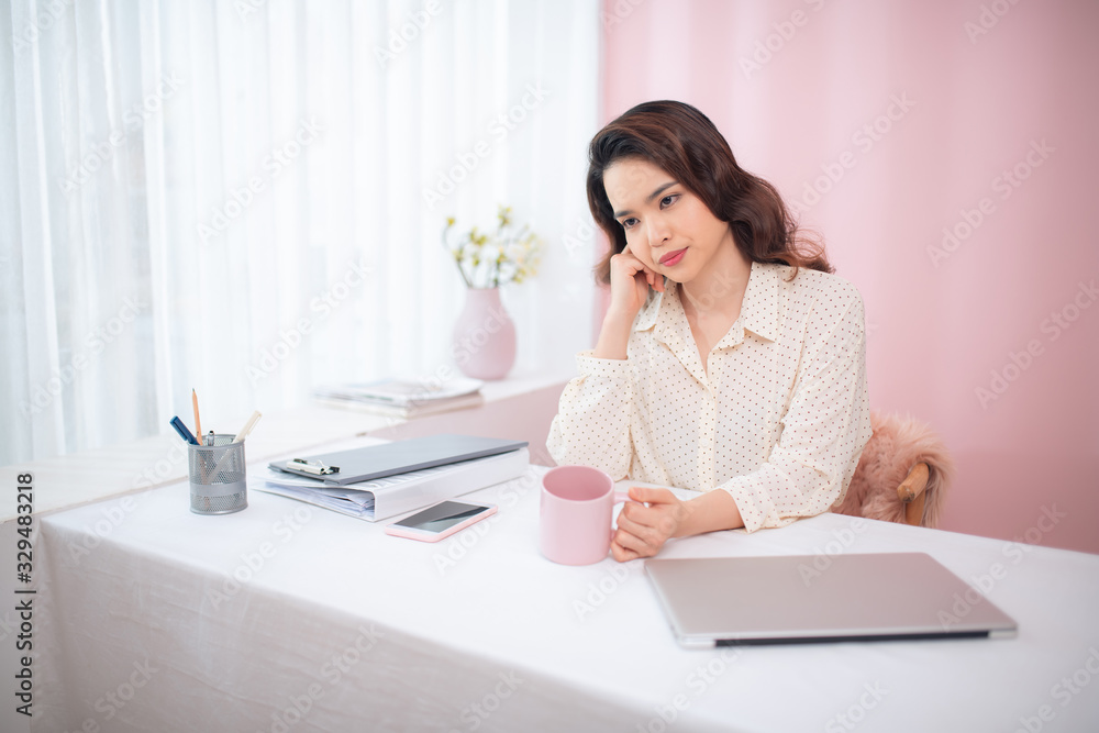 Portrait of young Asian business woman feeling tired at her office. Portrait of young Asian business woman feeling tired at her office.