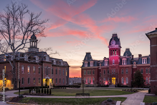 Dramatic image of Woodburn Hall at West Virginia University or WVU in Morgantown WV as the sun sets behind the illuminated historic building photo