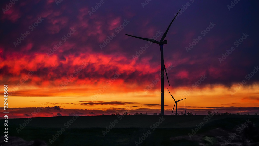 Obraz premium Wind generator triple set on scenic sundown