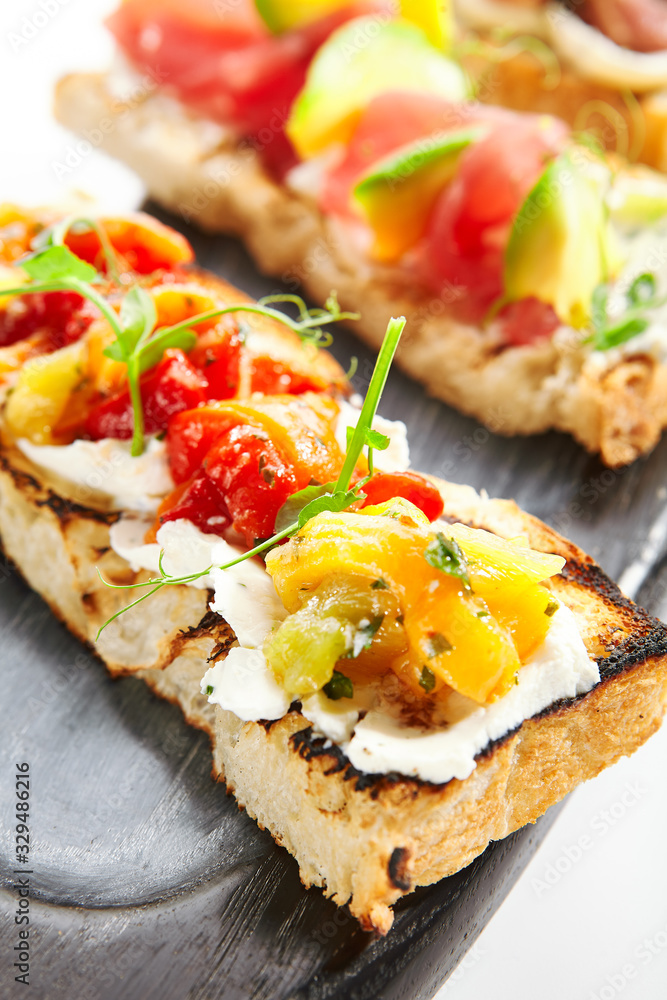 Delicious bruschetta with baked peppers closeup view Delicious bruschetta with baked peppers closeup view