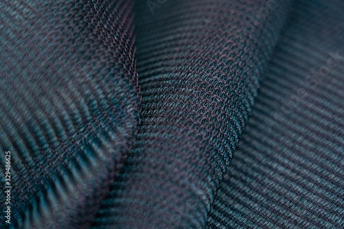 Shade net with detailed texture. Used in gardening, nursery, agriculture. Texture, weave pattern details close up. 