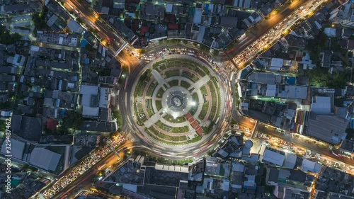 Hyperlapse timelapse of night city traffic on 4-way stop street intersection circle roundabout in bangkok, thailand. 4K UHD horizontal aerial view.