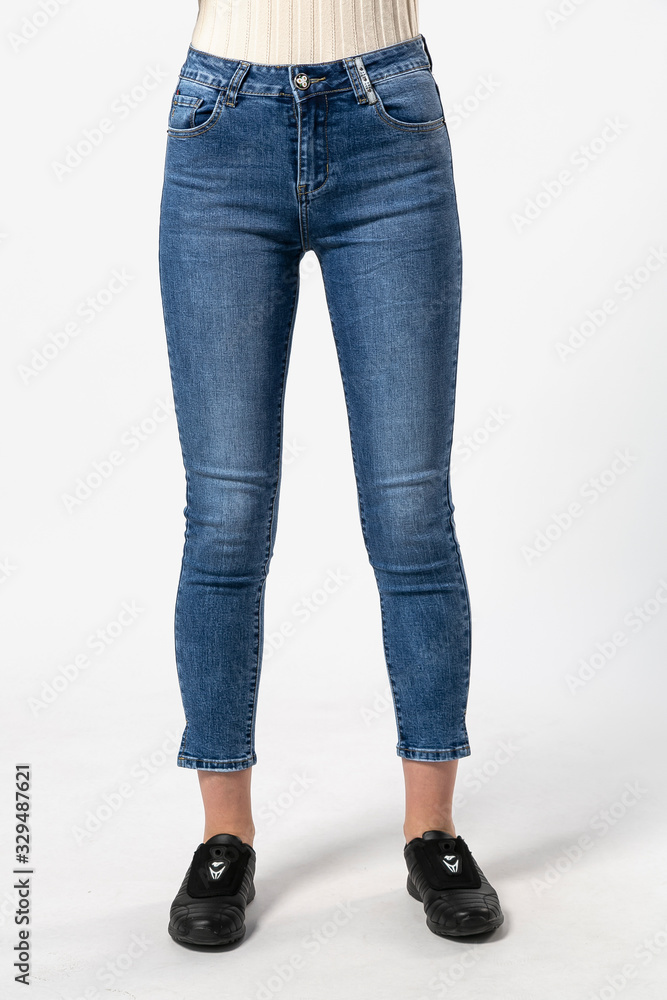 girl in jeans shows off jeans on white background close up, blue jeans girl in jeans shows off jeans on white background close up, blue jeans