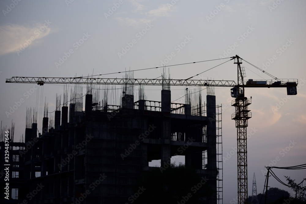 Construction building with crane over sunset time Construction building with crane over sunset time