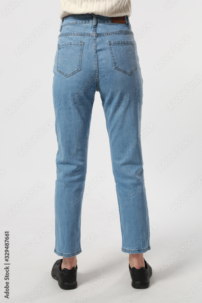 girl in jeans shows off jeans on white background close up, blue jeans girl in jeans shows off jeans on white background close up, blue jeans