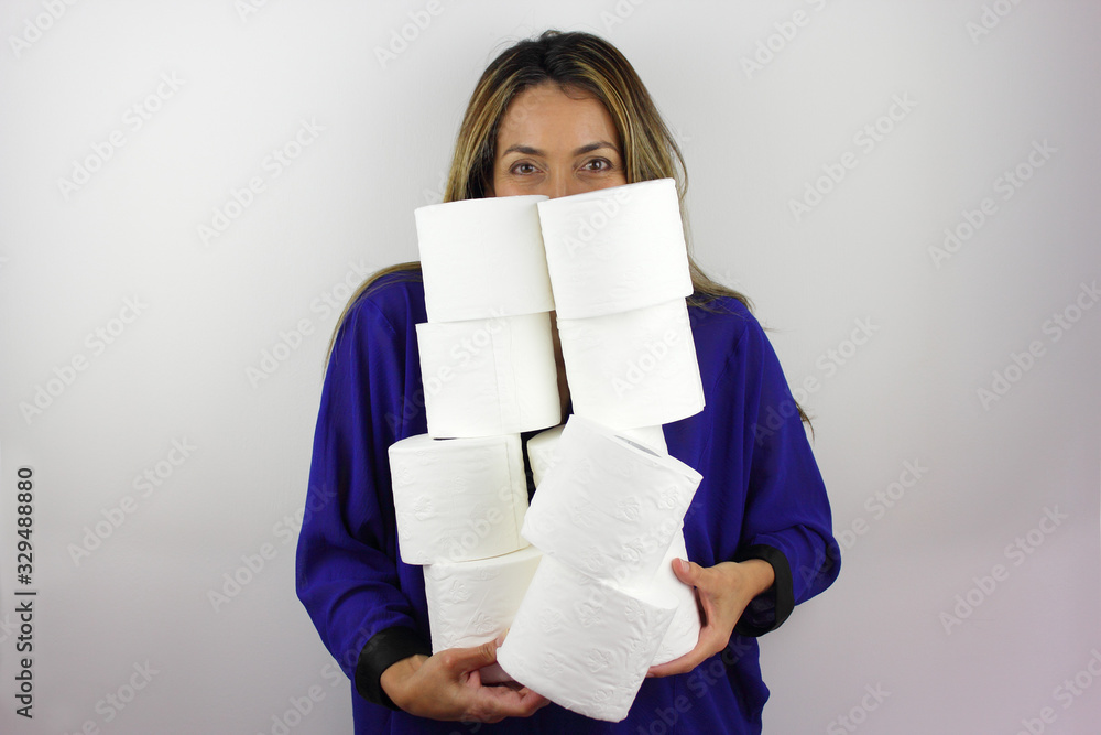 A beautiful woman balancing a handful of toilet paper rolls A beautiful woman balancing a handful of toilet paper rolls