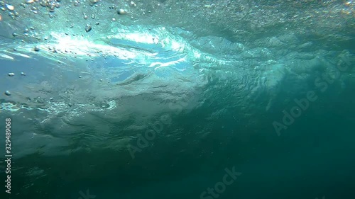 wave is breaking close-up and filming the barrel udner the water inside the wave. photo