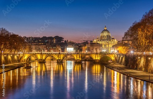 The Tiber river and St. Peters Basilica in the Vatican City, Italy, at twilight