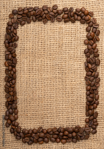 Coffee beans frame on burlap background