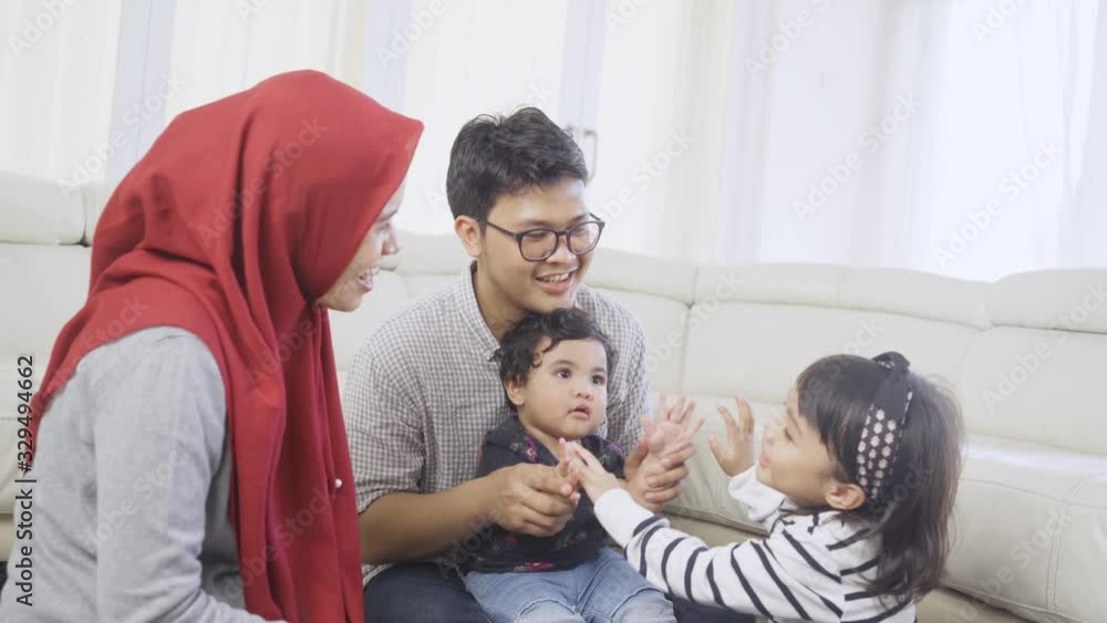 Cheerful muslim family playing together at home Cheerful muslim family playing together at home