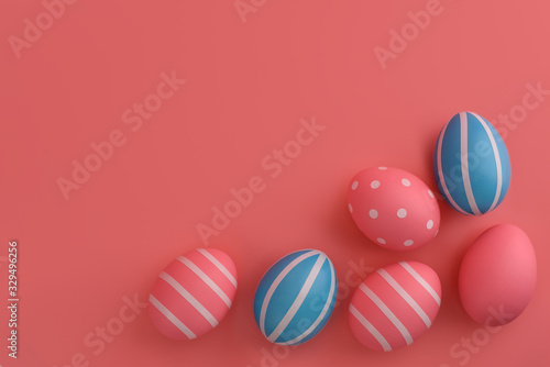 Blue and pink Easter eggs on a pink background. White stripes on Eggs . Happy Easter card. Copy space  top view  colourful image. 