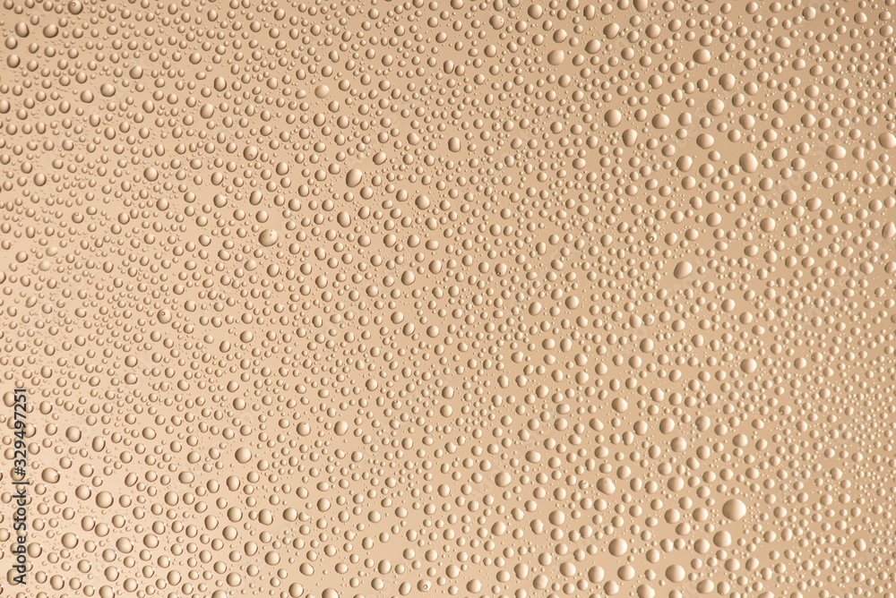 Close up photo of little water drops with contour shadow isolated on beige color background - obrazy, fototapety, plakaty 