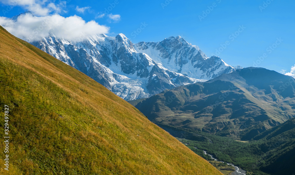 Huge beautiful snowy mountains on a sunny day while hiking in Svaneti Georgia