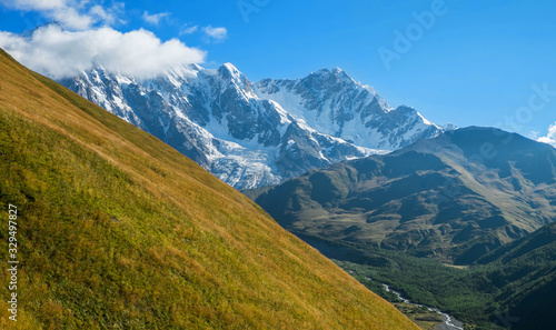 Huge beautiful snowy mountains on a sunny day while hiking in Svaneti Georgia